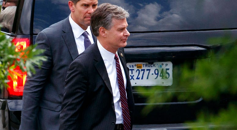 FBI Director Christopher Wray, right, leaves the White House, Monday, May 21, 2018, in Washington. (AP Photo/Evan Vucci)