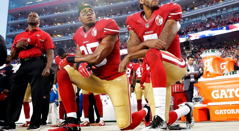 FILE - In this Monday, Sept. 12, 2016, file photo, San Francisco 49ers safety Eric Reid (35) and quarterback Colin Kaepernick (7) kneel during the national anthem before an NFL football game against the Los Angeles Rams in Santa Clara, Calif. NFL owners h