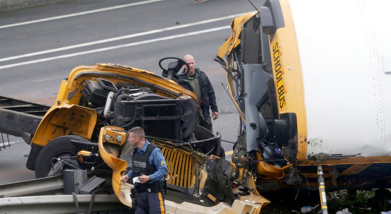In this May 17, 2018, file photo, emergency personnel work at the scene of a school bus and dump truck collision on Interstate 80 in Mount Olive, N.J. (AP Photo/Seth Wenig, File)