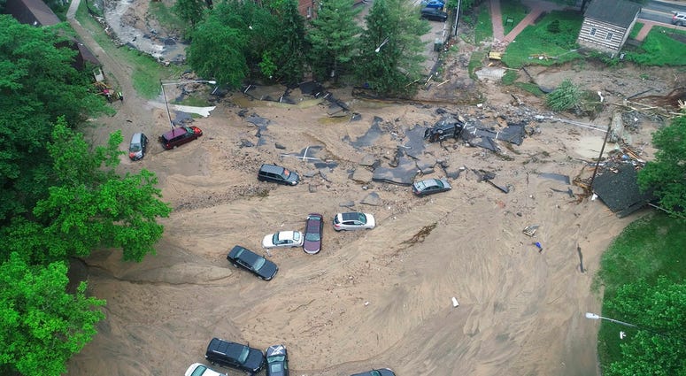 his image made from video provided by DroneBase shows vehicles swept by floodwater near the intersection of Ellicott Mills Drive and Main Street in Ellicott City, Md., Monday, May 28, 2018. Howard County Executive Allan Kittleman said Monday morning that