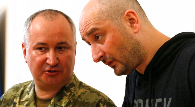 Russian journalist Arkady Babchenko, right, listens to Vasily Gritsak, head of the Ukrainian Security Service during a news conference at the Ukrainian Security Service on Wednesday, May 30, 2018. Babchenko turned up at a news conference in the Ukrainian