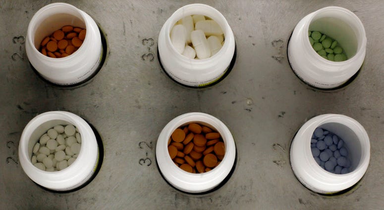FILE - In this June 14, 2011, file photo, various prescription drugs on the automated pharmacy assembly line at Medco Health Solutions in Willingboro, N.J. Medicare recipients cut back on pricey brand-name drugs but they still had to spend more on such me