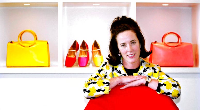 FILE - In this May 13, 2004 file photo, designer Kate Spade poses with shoes from her next collection in New York. Law enforcement officials say Tuesday, June 5, 2018, that New York fashion designer Kate Spade has been found dead in her apartment in an ap