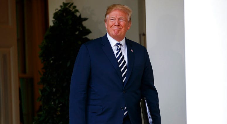 President Donald Trump arrives for a bill signing ceremony for the "VA Mission Act" in the Rose Garden of the White House, Wednesday, June 6, 2018, in Washington. (AP Photo/Evan Vucci)