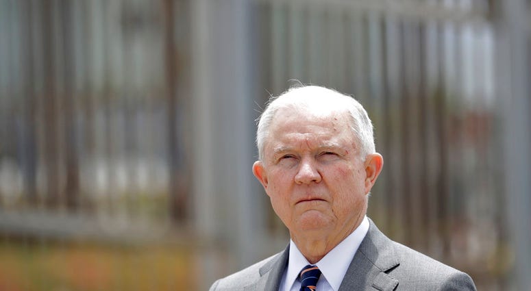 FILE - In this May 7, 2018, file photo, Attorney General Jeff Sessions listens during a news conference in San Diego near the border with Tijuana, Mexico. A judge allowed a lawsuit challenging U.S. immigration authorities for separating parents from their