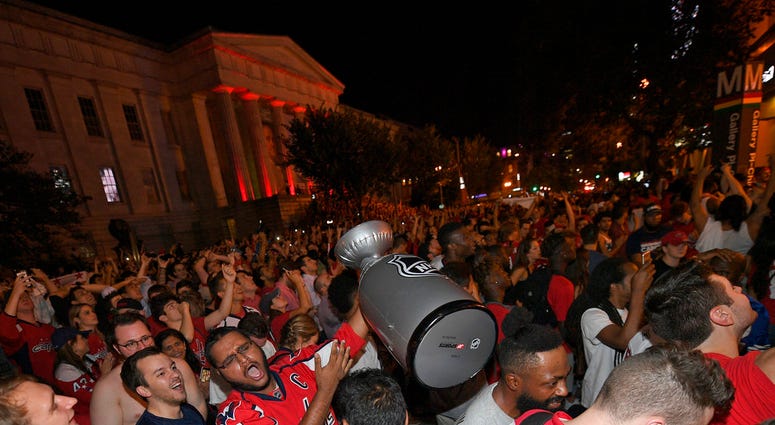 Washington Capitals fans celebrate in the streets outside Capital One Arena after Game 5 of the NHL hockey Stanley Cup Final between the Washington Capitals and the Vegas Golden Knights in Las Vegas, Thursday, June 7, 2018, in Washington. The Capitals won