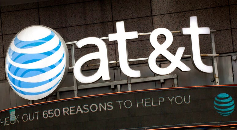 FILE - In this Monday, Oct. 24, 2016, file photo, the AT&T logo is positioned above one of its retail stores, in New York. The fate of the AT&T-Time Warner merger, a massive media deal opposed by the government that could shape how much consumers pay for