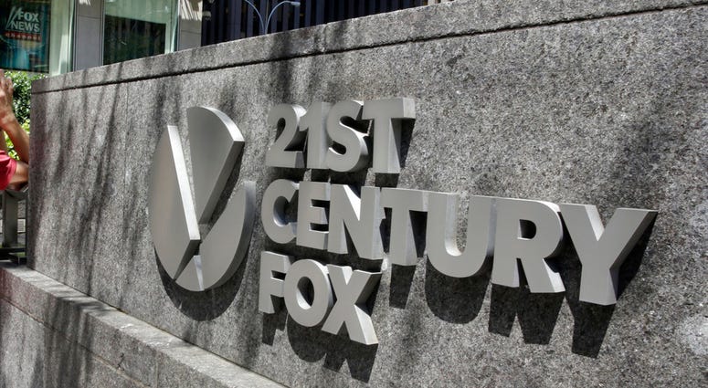 FILE - This Aug. 1, 2017, file photo shows the 21st Century Fox sign outside of the News Corporation headquarters building in New York. Disney has made a $52.4 billion all-stock offer for the bulk of Twenty-First Century Fox, including the studios behind