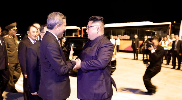 In this photo released by the Ministry of Communications and Information, Singapore, North Korean leader Kim Jong Un, center, is greeted before his departure, at Changi airport, following the summit with U.S. President Donald Trump, Tuesday, June 12, 2018