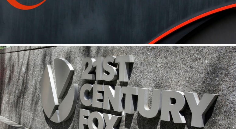 FILE- This combo of file photos shows the 21st Century Fox sign outside of the News Corporation headquarters building on Aug. 1, 2017, in New York, bottom, and a Comcast sign on Oct. 12, 2017, in Hialeah, Fla. Comcast is making a $65 billion bid for Fox's