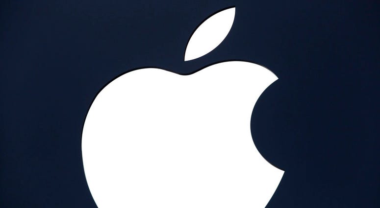 FILE - In this July 28, 2016 file photo, the Apple logo is shown on a sign hanging in front of a new Apple Store, in the Williamsburg section in the Brooklyn borough of New York. Apple is closing a security gap that allowed outsiders to pry personal infor