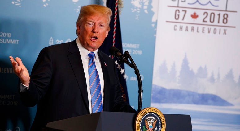 FILE - In this June 9, 2018 file photo, President Donald Trump speaks during a news conference at the G-7 summit in La Malbaie, Quebec, Canada. New York Attorney General sues the Trump Foundation, Thursday, June 14, saying it engaged in a pattern of illeg
