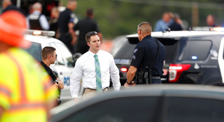 Law enforcement officials investigate the scene of a shooting in a parking lot behind a dentist's office, Thursday, June 14, 2018, in Westminster, Colo. (AP Photo/David Zalubowski)