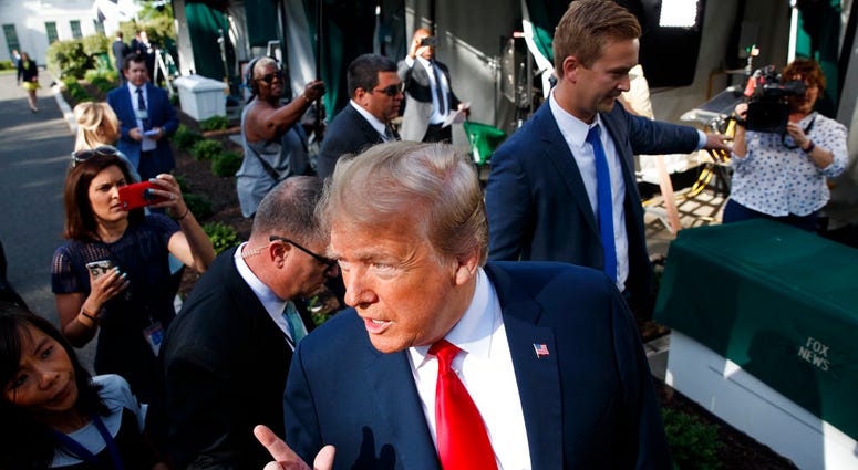 President Donald Trump speaks to reporters on the North Lawn of the White House, Friday, June 15, 2018, in Washington. (AP Photo/Evan Vucci)