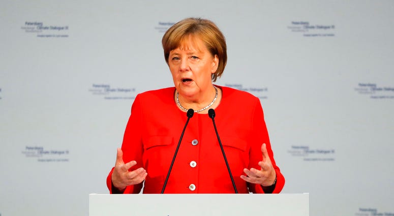 German Chancellor Angela Merkel delivers her speech at a meeting in preparation for a climate change conference that takes place later this year in Poland's city Katowice, in Berlin, Tuesday, June 19, 2018. (AP Photo/Markus Schreiber, Pool)