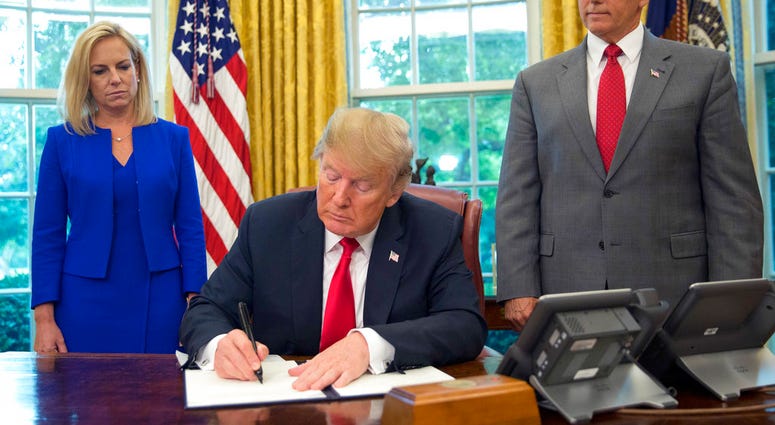 President Donald Trump signs an executive order to keep families together at the border.(AP Photo/Pablo Martinez Monsivais) President Donald Trump signs an executive order to keep families together at the border.(AP Photo/Pablo Martinez Monsivais)