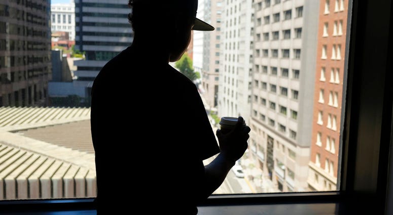 In this photo taken Friday, June 22, 2018, an 18-year-old Honduran who said he suffered abuse inside a Virginia immigration detention facility poses in front of a window in San Francisco. (AP Photo/Eric Risberg)