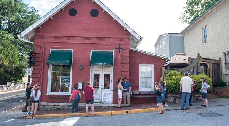 Passersby gather to take photos in front of the Red Hen Restaurant, Saturday, June 23, 2018, in Lexington, Va. (AP Photo/Daniel Lin)