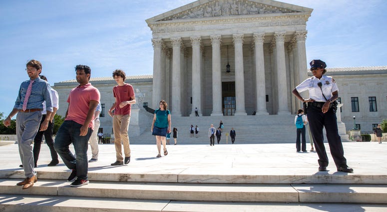 Visitors depart the Supreme Court early Monday, June 25, 2018. The justices are expected to hand down decisions this week as the court's term comes to a close. (AP Photo/J. Scott Applewhite)