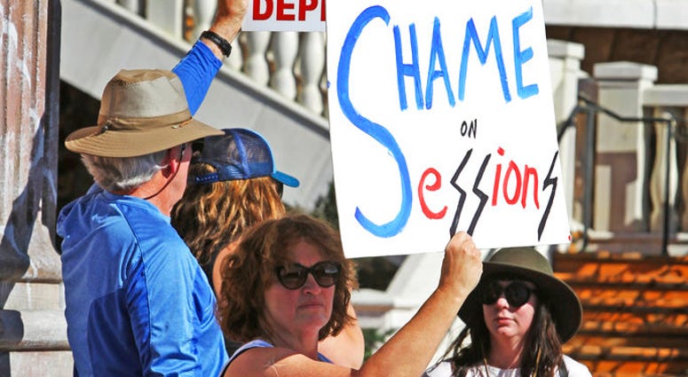 Mary Turnbusch from Carson City Nev, leads protests outside the Peppermill Resort-Casino in Reno Nev, as Attorney General Jeff Sessions delivers remarks on immigration to NASRO, a School Safety Conference, Monday, June 25, 2018.(AP Photo by Lance Iversen)