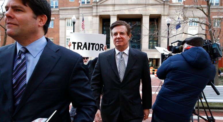 FILE - In this March 8, 2018, file photo, Jason Maloni, left, former Trump campaign chairman Paul Manafort's spokesman, left, walks with Paul Manafort, center, as they leave the Alexandria Federal Courthouse after an arraignment hearing in Alexandria, Va.
