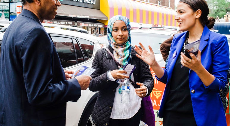 This May 6, 2018 photo provided by the Alexandria Ocasio-Cortez Campaign shows candidate Alexandria Ocasio-Cortez, right, during a Bengali community outreach in New York. (Corey Torpie/Courtesy Alexandria Ocasio-Cortez Campaign via AP)