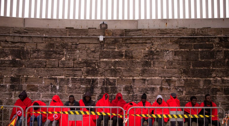 In this Wednesday, June 27, 2018 photo, migrants rest at the port of Tarifa, southern Spain, as they wait to be transported. (AP Photo/Emilio Morenatti)
