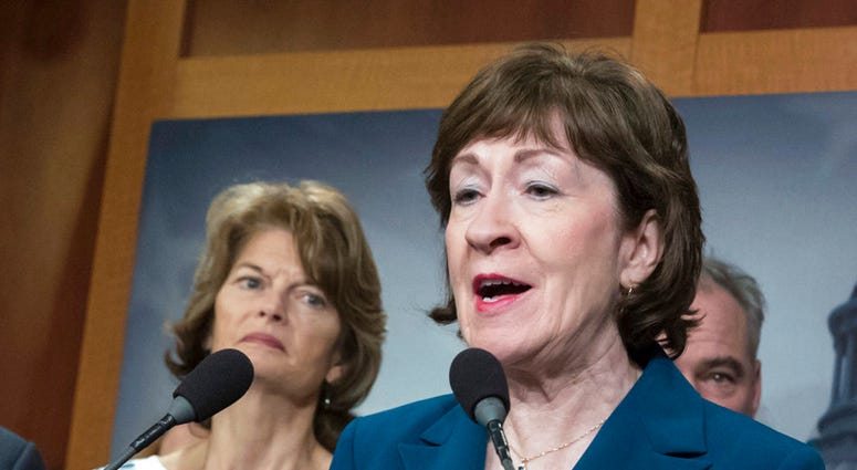 Senator Susan Collins flanked by Senator Lisa Murkowski