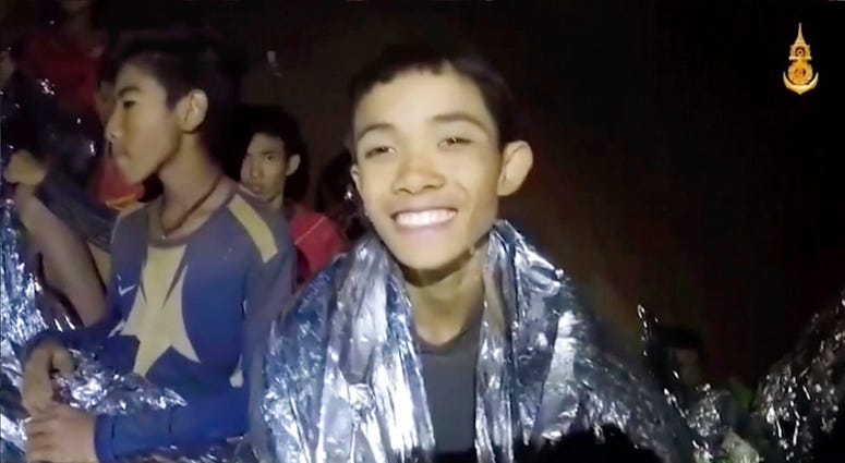 In this July 3, 2018, image taken from video provided by the Royal Thai Navy Facebook Page, Thai boys smile as Thai Navy SEAL medic help injured children inside a cave in Mae Sai, northern Thailand. (Royal Thai Navy Facebook Page via AP) In this July 3, 2018, image taken from video provided by the Royal Thai Navy Facebook Page, Thai boys smile as Thai Navy SEAL medic help injured children inside a cave in Mae Sai, northern Thailand. (Royal Thai Navy Facebook Page via AP)
