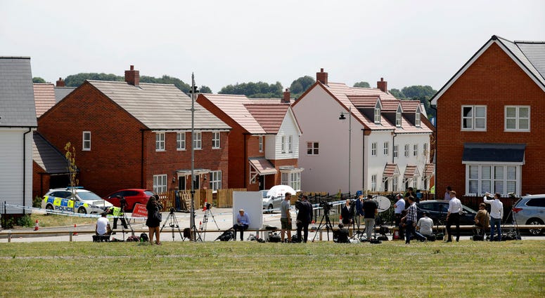 Members of the media stand outside a police cordon stopping people seeing a property shielded from view, around to the left out the picture, that police have been guarding in Amesbury, England, Thursday, July 5, 2018. British officials were seeking clues