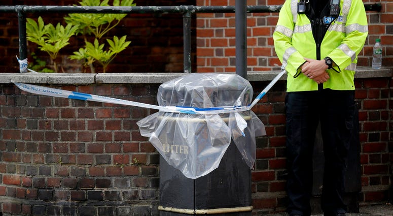 FILE - In this file photo dated Thursday, July 5, 2018, an unidentified British police officer guards a cordon in Salisbury, England. Officials say Saturday July 7, 2018, that a police officer is being tested for possible medical problems related to the r