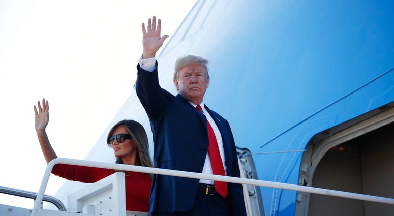 First lady Melania Trump looks on as President Donald Trump speaks with reporters before boarding Marine One on the South Lawn of the White House, Tuesday, July 10, 2018, in Washington. (AP Photo/Evan Vucci)
