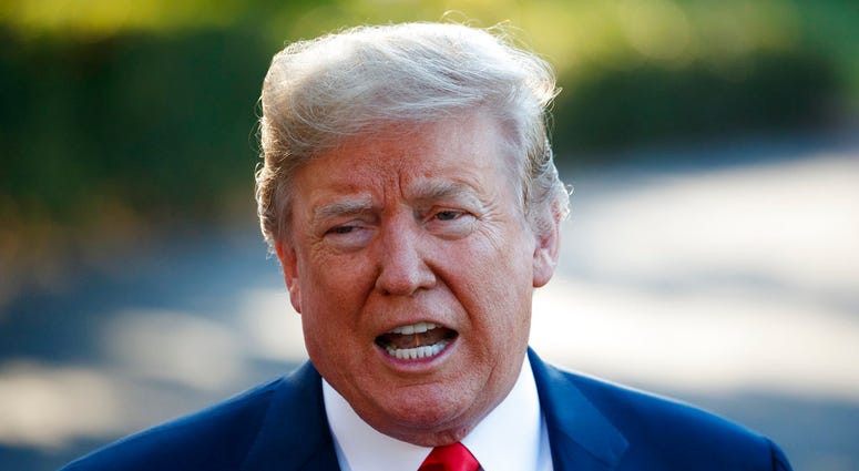 President Donald Trump speaks with reporters before boarding Marine One on the South Lawn of the White House, Tuesday, July 10, 2018, in Washington. (AP Photo/Evan Vucci)