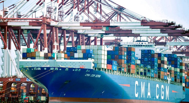 In this July 6, 2018, photo, a container ship is docked at a port in Qingdao in eastern China's Shandong Province. In this July 6, 2018, photo, a container ship is docked at a port in Qingdao in eastern China's Shandong Province. (Chinatopix via AP)