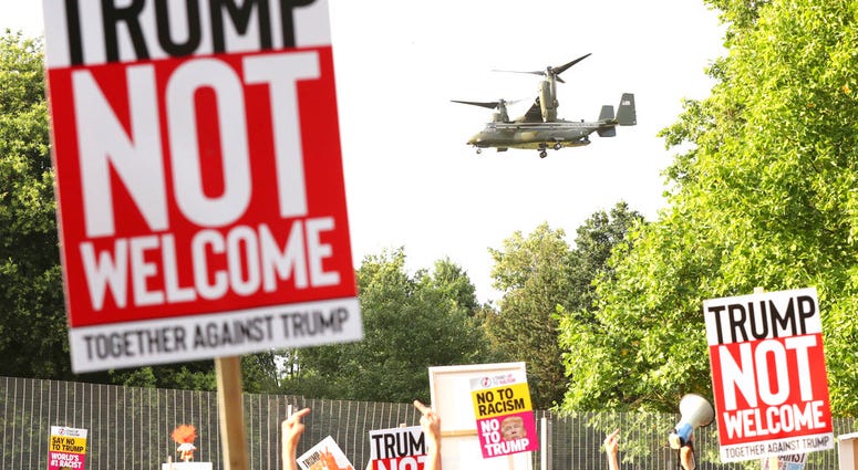A helicopter leaves the grounds of the US ambassador residence in Regent's Park, London, while demonstrators protest against the visit of US President Donald Trump Thursday July 12, 2018. (Gareth Fuller/PA via AP)