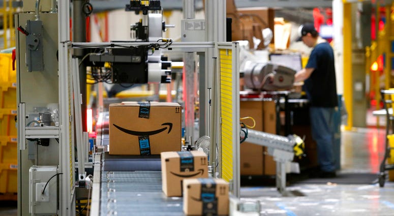 - In this Aug. 3, 2017, file photo, packages pass through a scanner at an Amazon fulfillment center in Baltimore. (Photo/Patrick Semansky, File)