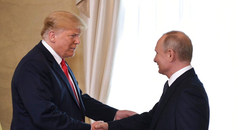 U.S. President Donald Trump and Russian President Vladimir Putin, right, welcome each other at the Presidential Palace in Helsinki, Finland, Monday, July 16, 2018. (Alexei Nikolsky, Sputnik, Kremlin Pool Photo via AP)