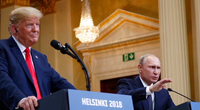 U.S. President Donald Trump, left, listens to Russian President Vladimir Putin during a press conference after their meeting at the Presidential Palace in Helsinki, Finland, Monday, July 16, 2018. (AP Photo/Pablo Martinez Monsivais)