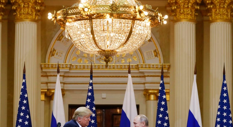 U.S. President Donald Trump, left, shakes hand with Russian President Vladimir Putin during a press conference after their meeting at the Presidential Palace in Helsinki, Finland, Monday, July 16, 2018. (AP Photo/Alexander Zemlianichenko)