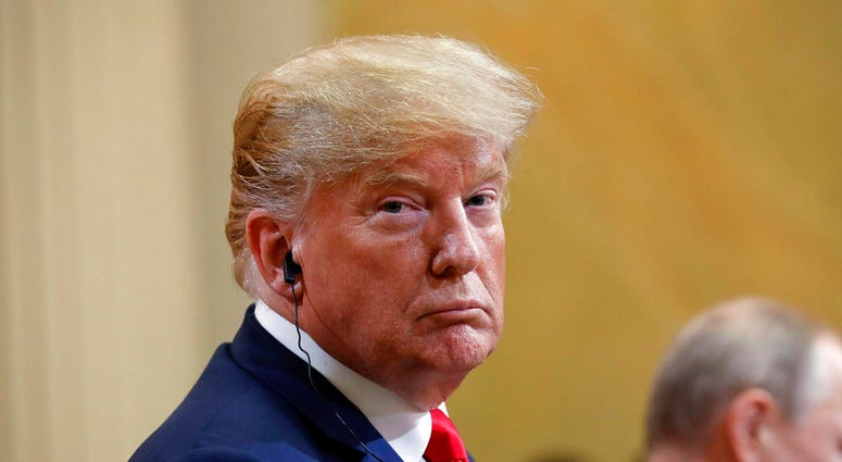 U.S. President Donald Trump, left, looks over as he listens to Russian President Vladimir Putin, right, speak during their joint news conference at the Presidential Palace in Helsinki, Finland, Monday, July 16, 2018. (AP Photo/Pablo Martinez Monsivais)