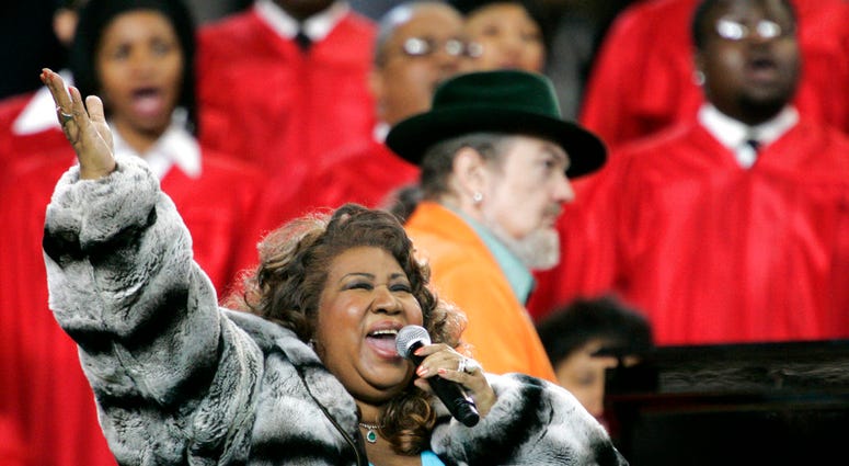 In this Feb. 5, 2006 file photo, Aretha Franklin and Dr. John, background on piano, perform the national anthem before the Super Bowl XL football game in Detroit. (AP Photo/Gene J. Puskar, File)
