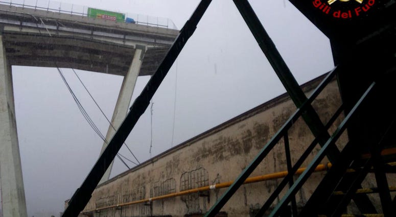 This photo released by the Italian firefighters, shows a truck stopped where the Morandi highway bridge collapsed in Genoa, Tuesday, Aug. 14, 2018. (Vigili Del Fuoco via AP)