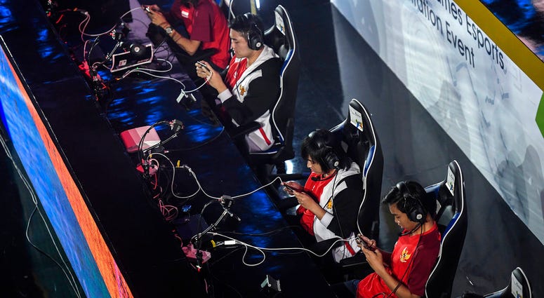In this Sunday Aug. 26, 2018 photo, the Indonesian team compete in the eSports exhibition at the 18th Asian Games Arena of Valor, Britama Arena, Jakarta.(Dhemas Reviyanto,INASGOC via AP) In this Sunday Aug. 26, 2018 photo, the Indonesian team compete in the eSports exhibition at the 18th Asian Games Arena of Valor, Britama Arena, Jakarta. (Dhemas Reviyanto,INASGOC via AP)