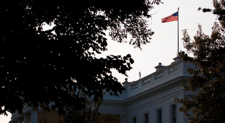An American flag above the White House flies at full-staff less than 48 hours after the death of Sen. John McCain, Monday, Aug. 27, 2018, in Washington. (AP Photo/Evan Vucci)