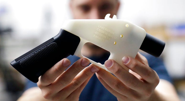 FILE - In this Aug. 1, 2018, file photo, Cody Wilson, with Defense Distributed, holds a 3D-printed gun called the Liberator at his shop in Austin, Texas.(AP Photo/Eric Gay, file) FILE - In this Aug. 1, 2018, file photo, Cody Wilson, with Defense Distributed, holds a 3D-printed gun called the Liberator at his shop in Austin, Texas.(AP Photo/Eric Gay, file)