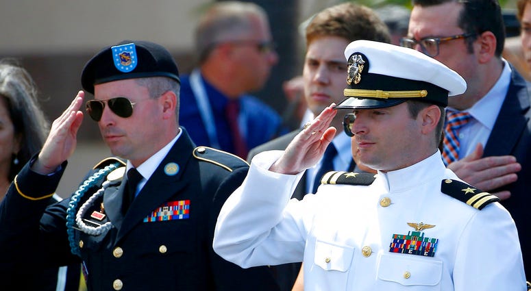 Jimmy & Jack McCain salute their father's casket