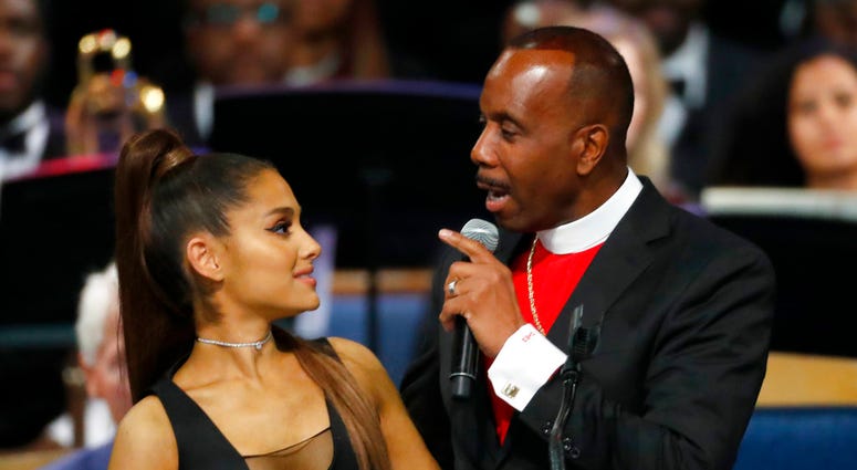 Bishop Charles H. Ellis, III, right, speaks with Ariana Grande after she performed during the funeral service for Aretha Franklin at Greater Grace Temple, Friday, Aug. 31, 2018, in Detroit.