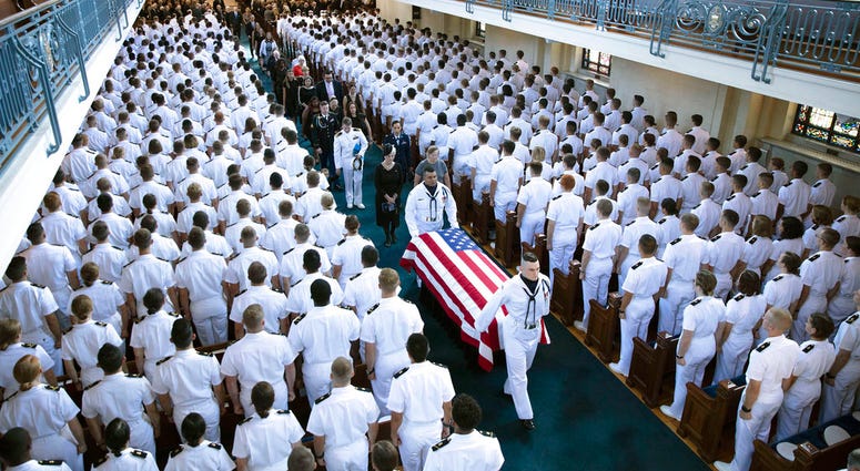 In this image proved by the family of John McCain, the family follows as the casket of Sen. John McCain, R-Ariz., is moved from the Chapel on the grounds of the United States Navel Academy