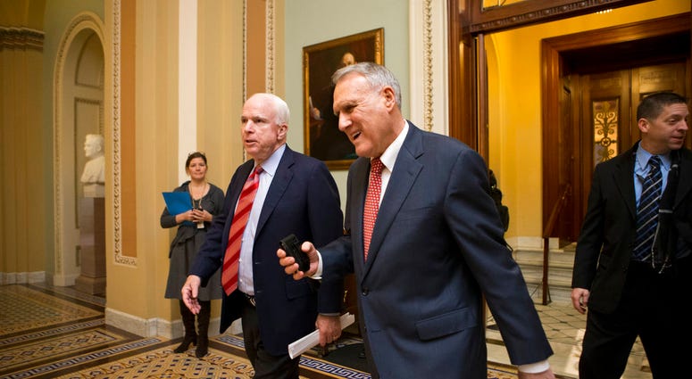 In this Dec. 30, 2012, file photo, Sen. John McCain, R-Ariz., left, and Senate Minority Whip Jon Kyl, R-Ariz., leave the chamber as the Senate