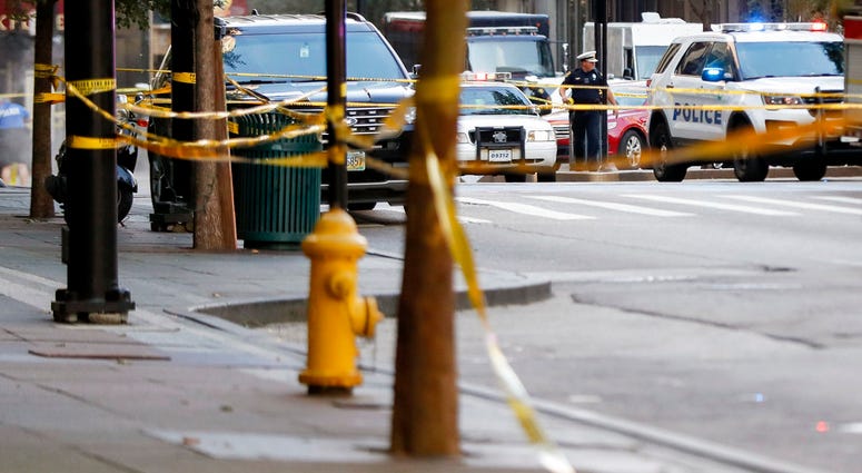 An area is cordoned off with police tape as emergency personnel and police respond to reports of an active shooter situation near Fountain Square, Thursday, Sept. 6, 2018, in downtown Cincinnati. (AP Photo/John Minchillo)